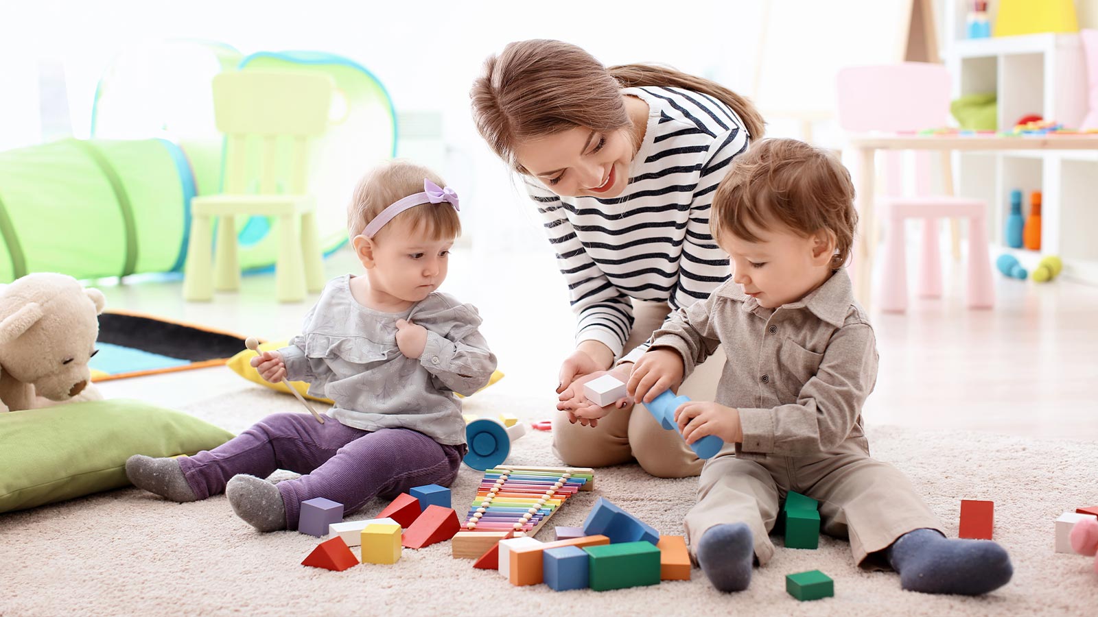 Due bambini giocano con la tata del Livì, hotel per bambini a Livigno